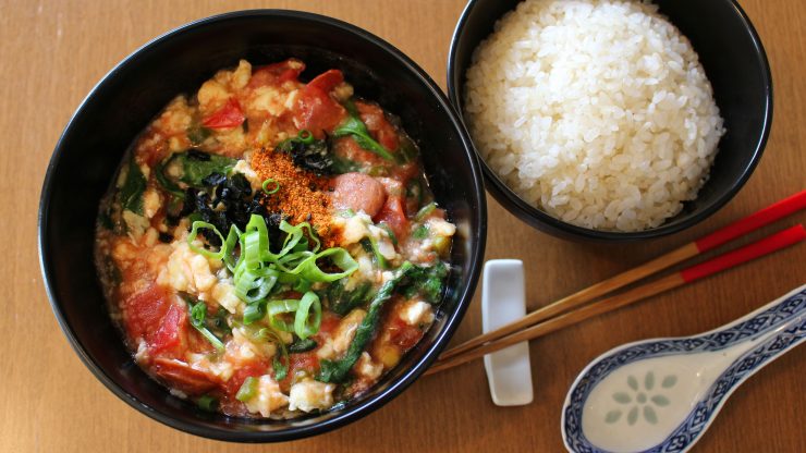 Tomato egg stirfry with rice and chopsticks